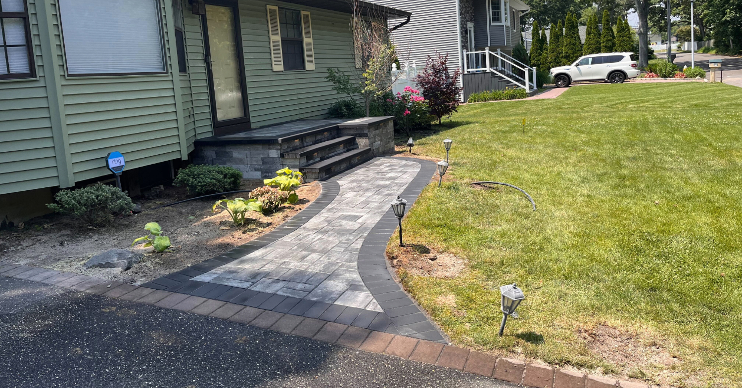 Curved paver walkway with contrasting border leading to a front entry