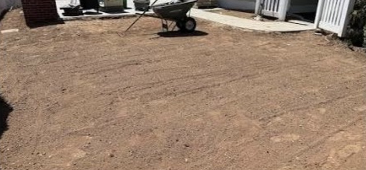 Bare graded backyard soil prepped before sod installation